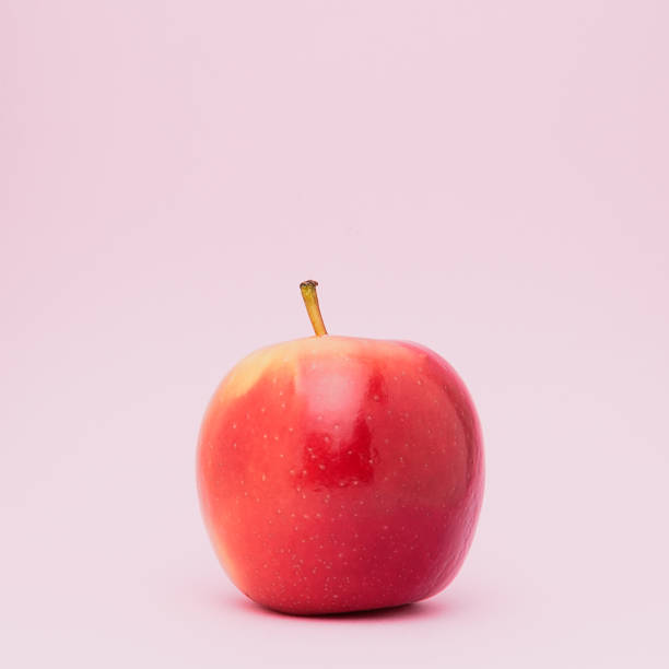 istock A  fresh ripped red apple isolated on pink background. 994725594