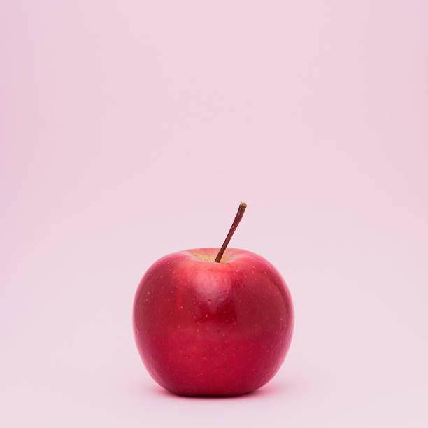 istock A  fresh ripped red apple isolated on pink background. 994728158
