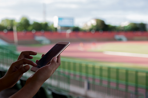 Using smartphone for communications at football stadium