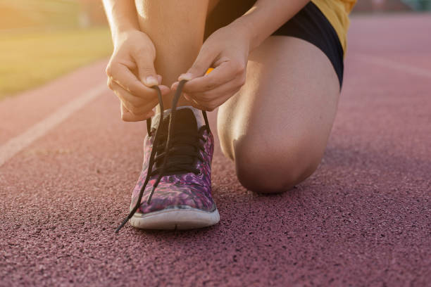 istock Woman runner tying shoelaces , Run for life 994730844