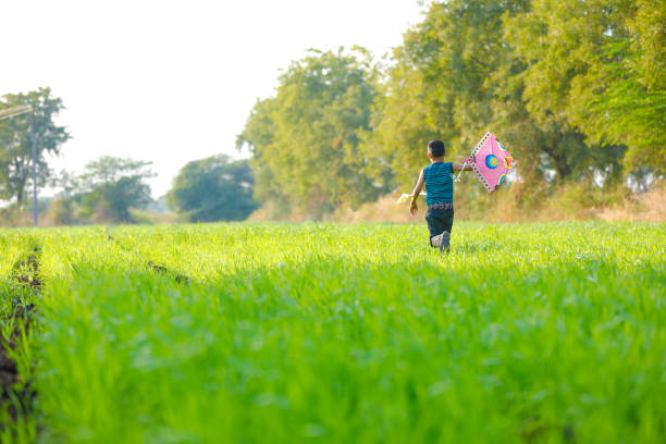 istock indian child playing with kite 994733490