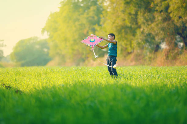 istock indian child playing with kite 994735550