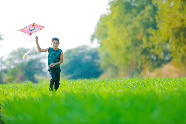 istock indian child playing with kite 994735952