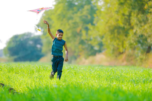 istock indian child playing with kite 994735958