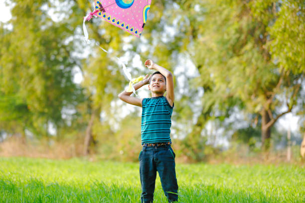 istock indian child playing with kite 994736126