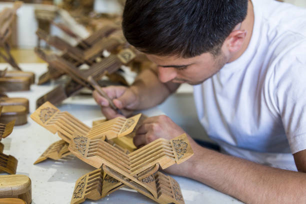 Master making creating ingenious rihals wooden book stands from Bukhara, Uzbekistan