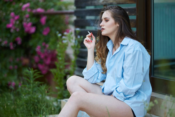 istock Young woman smoking outdoor 994741046