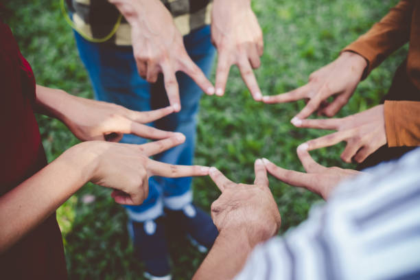 istock Stacking hands of young teen student, teamwork, togetherness and cooperation concept 994750996