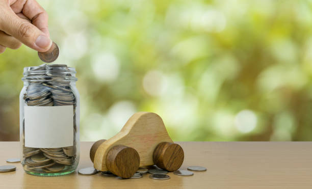 istock Coins in glass bottle, saving money for Car 994751162