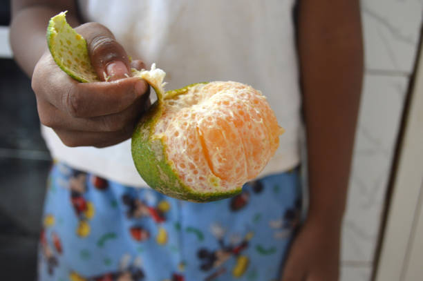 istock Peel a green tangerine 994753518