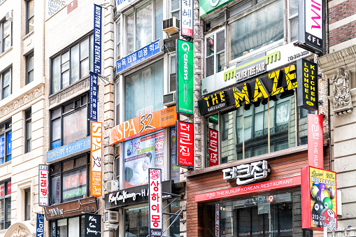 New York City, USA - April 7, 2018: Manhattan NYC buildings near Korean Town, Korea Way with many stores, shops signs on west 32nd street road