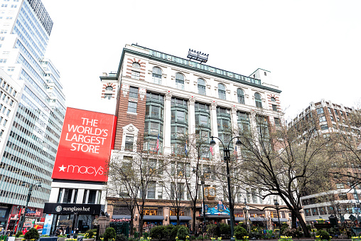 New York City, USA - April 7, 2018: Street view of urban NYC Herald Square Midtown with Macy's store, park, Sunglass Hut