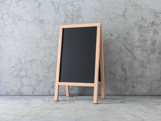 istock Wooden Menu Black Board Mockup in empty concrete room, easel Stand 994770032