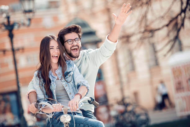 istock Cheerful couple having fun on bike 994775040