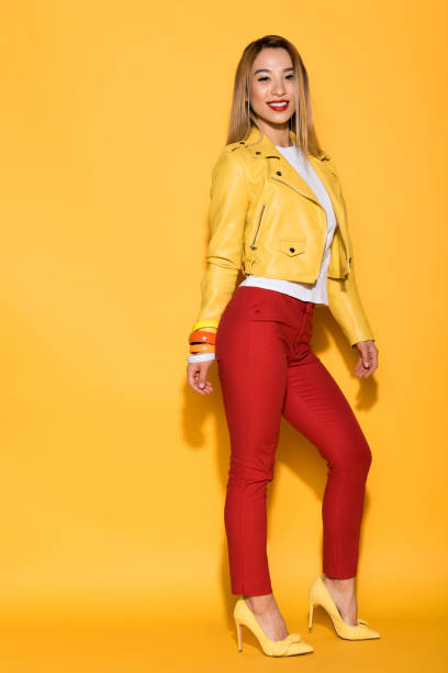 istock stylish asian female model posing on yellow background 994775564