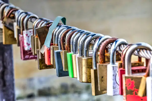 Side view of lovelocks attached to the fence of a bridge in Valkenburg, The Netherlands