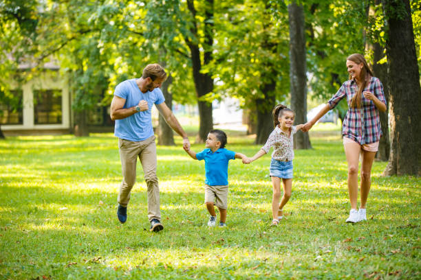 istock Playful family running in the park while holding hands 994777648