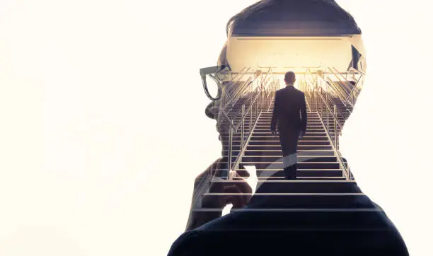 Photo of Double exposure of a businessman and stairs. Success of business concept.