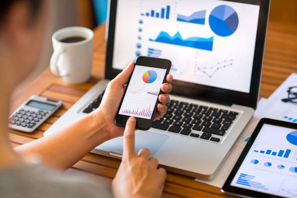 istock Woman working with smart phone and laptop computer 994786362