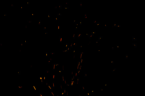 Chispas y fuego sobre fondo negro photo