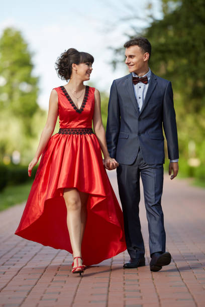 istock Elegant couple walking in the park 994792816