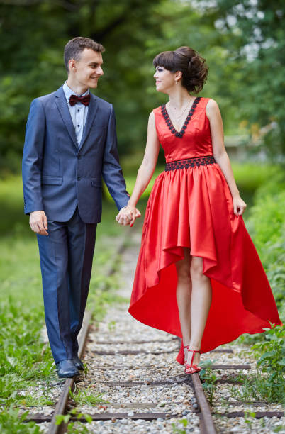 istock Elegant couple walking in the park 994792860