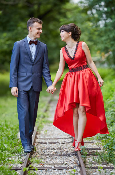istock Elegant couple walking in the park 994792872