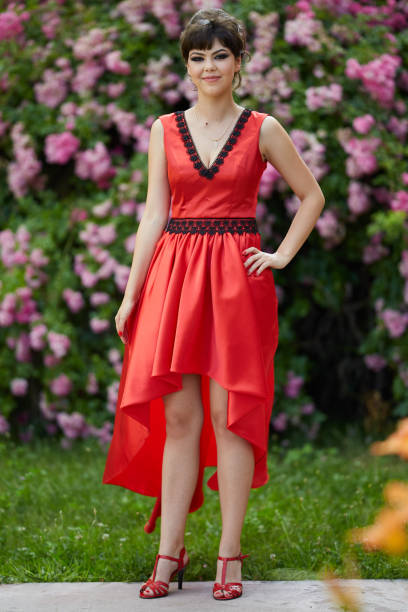 istock Beautiful young lady in red dress 994793036