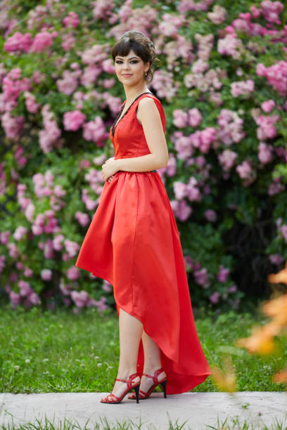 istock Beautiful young lady in red dress 994793044