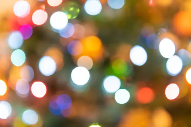 Photo of Background of blurred colorful, multicolored, multi-colored, Christmas ornament bokeh round circles of green, red, orange, blue colors