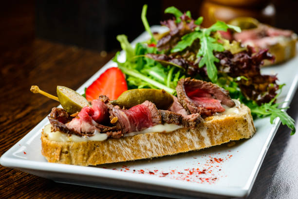 istock Delicious dish. Fresh bread with juicy meat slices served with s 994801856