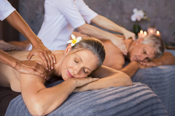 coppia matura che ha un massaggio in spa - spa treatment health spa massaging couple foto e immagini stock