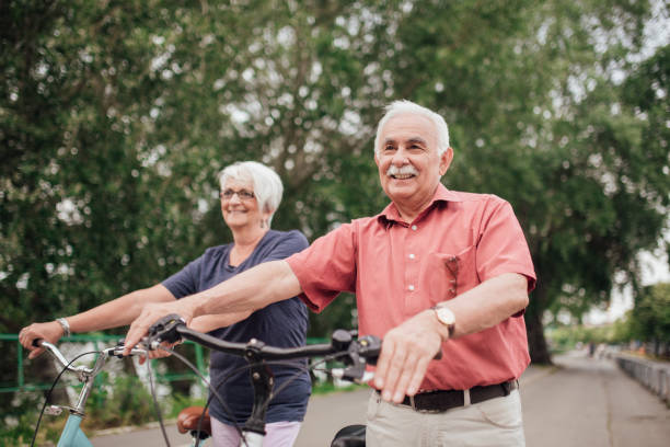 istock Senior couple walking by their bicycles 994810232