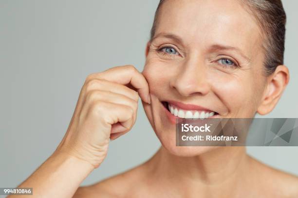 Beauty Mature Woman Pulling Perfect Skin Stock Photo - Download Image Now - Skin, Human Face, Women