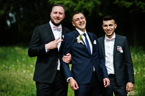 istock Groomsmen and groom posing outdoors on the wedding day. 994814404