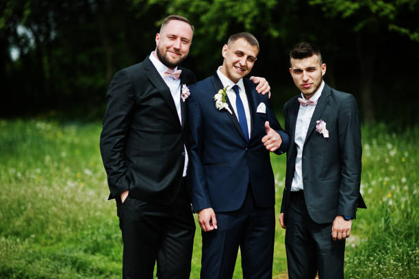 istock Groomsmen and groom posing outdoors on the wedding day. 994814444