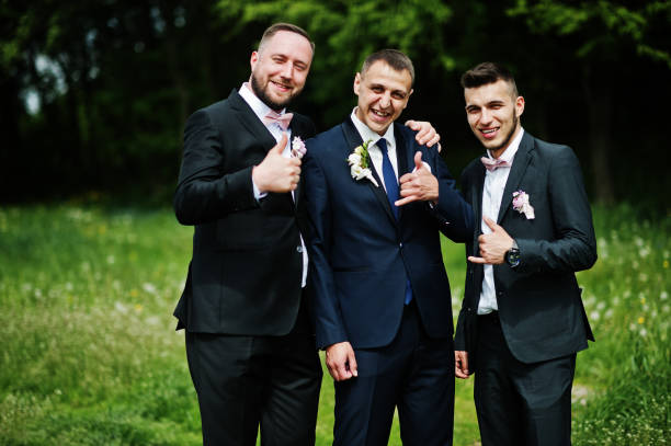 istock Groomsmen and groom posing outdoors on the wedding day. 994814466