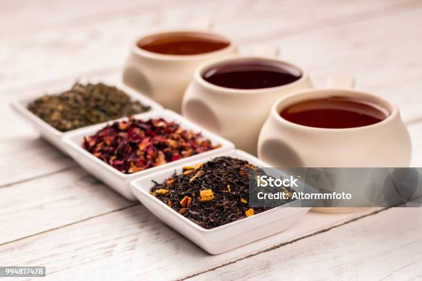 Three Kind Of Tea In Cups On Wooden Table Stock Photo - Download Image Now - Tea - Hot Drink, Variation, Dried Tea Leaves