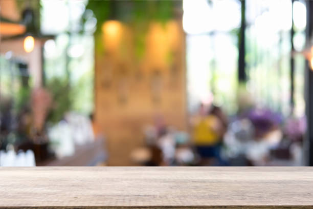 istock Empty wooden table and blurred cafe background, can be used for display or montage your products 994817606