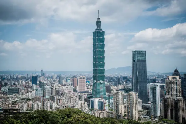 Photo of Skyscrapers of a modern city with overlooking perspective under blue sky in Taipei, Taiwan