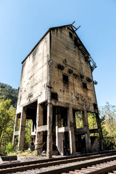 istock Abandoned retro concrete loading receiving terminal building exterior in Thurmond, West Virginia ghost town with decaying structure walls, windows, railroad 994826278