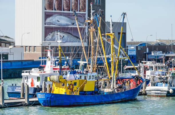 Breskens, The Netherlands, July 2nd, 2018: Fishing trailer in the harbour, with the grainsilo in the background