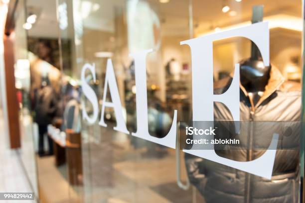Closeup Of Sale Sign On Clothes Clothing Apparel Retail Store Shop Window In Shopping Mall Stock Photo - Download Image Now