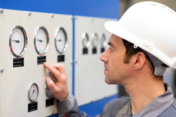 istock industrial workers read the instruments of a machine 994834646
