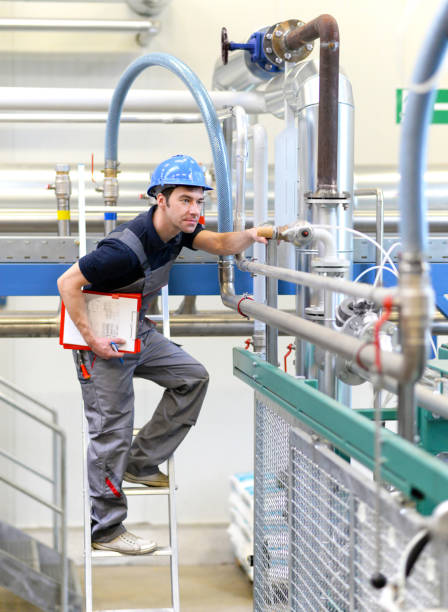 istock industrial workers inspect the technology of a plant for function - assembler in working clothes 994837484