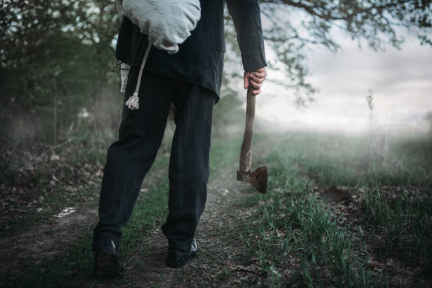 istock Slayer with an axe carries the victim's body 994838338