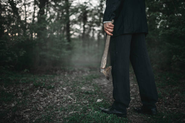 istock Bloody murderer with an axe, serial maniac concept 994841322