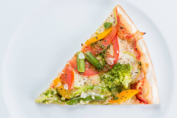 Slice of vegetarian pizza with broccoli, green beans, olives and