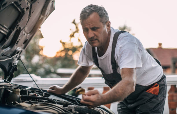 istock Mechanic repairing car 994841696