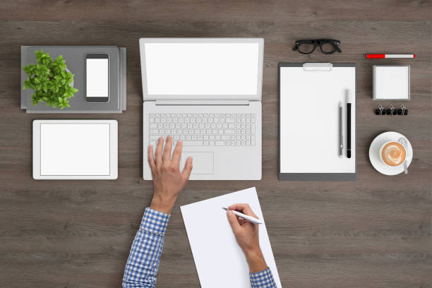 istock Man writing on a blank piece of paper, copy space template - top view 994842328